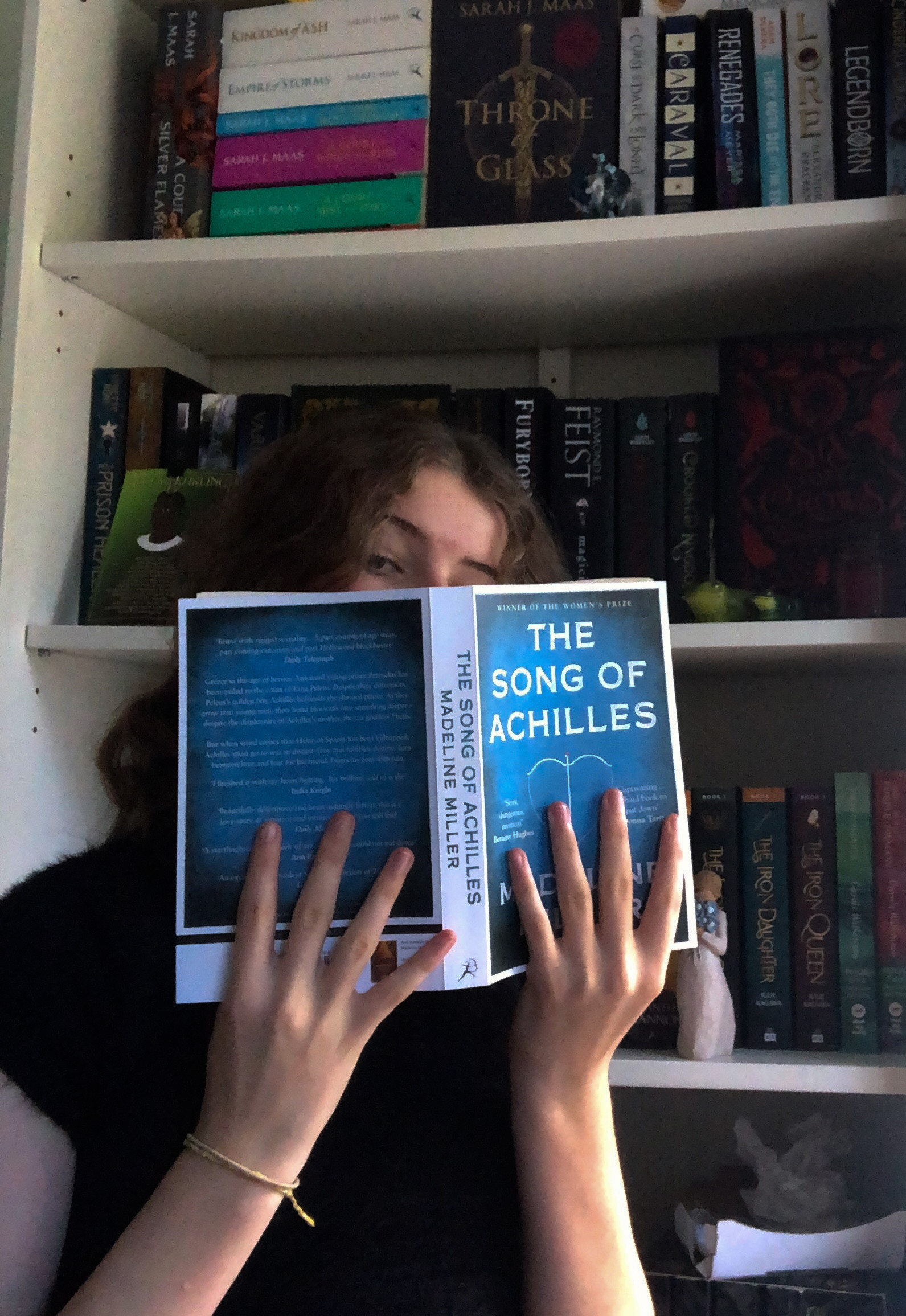 photo of myself holding book over face